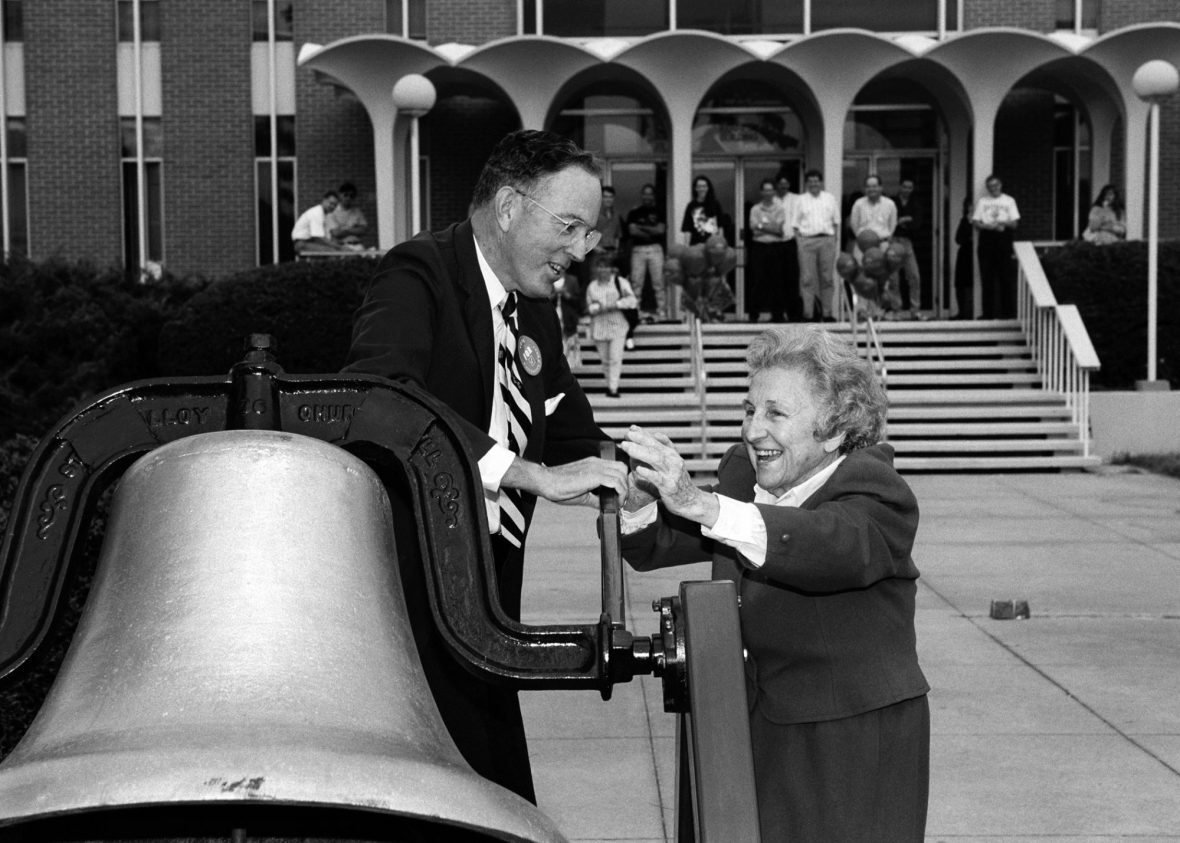 E. K. Fretwell ringing a bell with Bonnie Cone