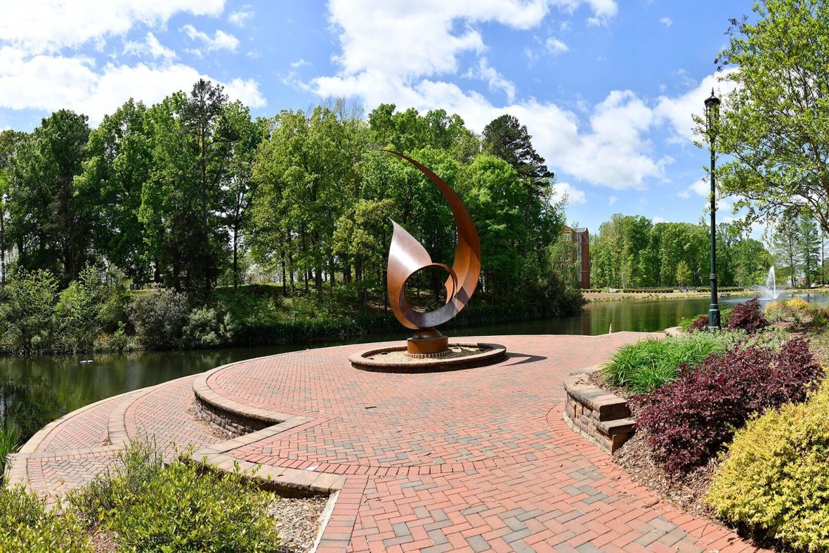 Statue at pond at charlotte campus