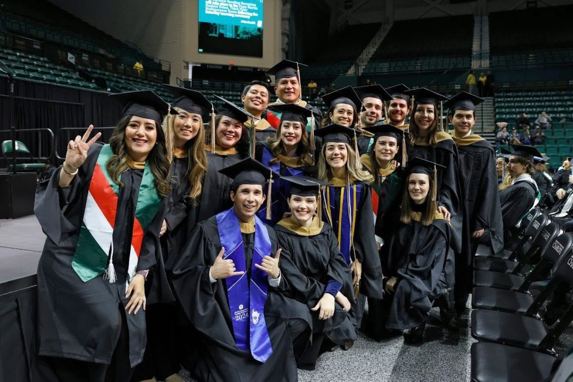 Group of students taking a group photo at graduation